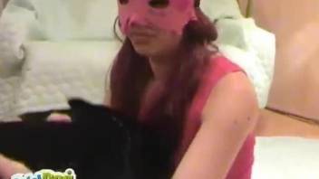 Zoophile in pink mask tries to have fun with her pretty pet