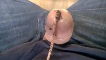 Clothed man masturbates with worms into his penis