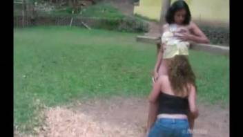 Women outdoors engaging in bestiality with a horse's penis