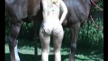 Lady bares in park and takes horse's cock into pussy