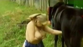 Cute blonde jerking an animal's dick with pleasure