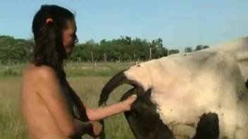 Horny chick shoves her fist deep into the beast's cunt